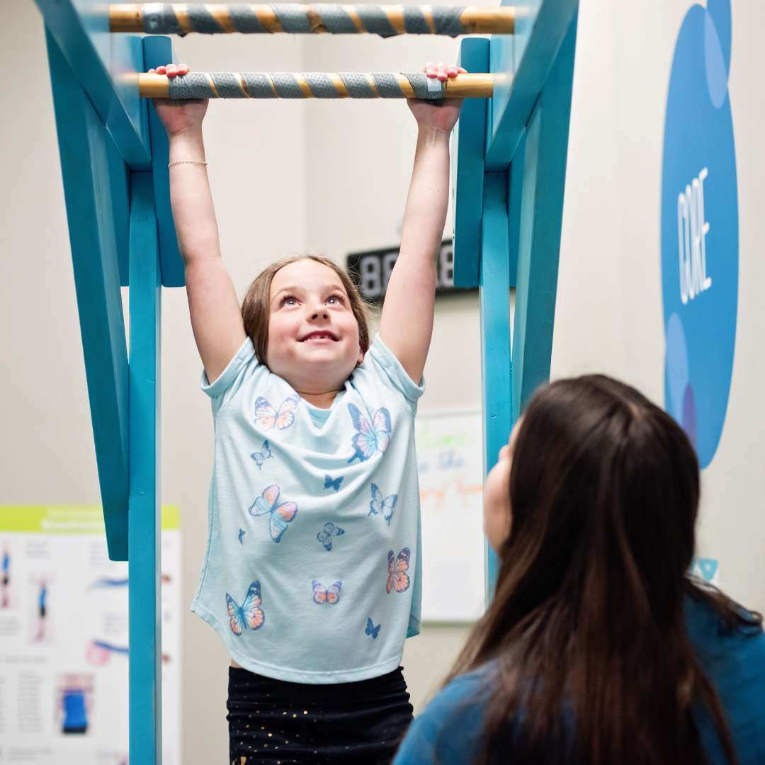 Girl on monkey bars